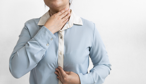 喉を押さえる人